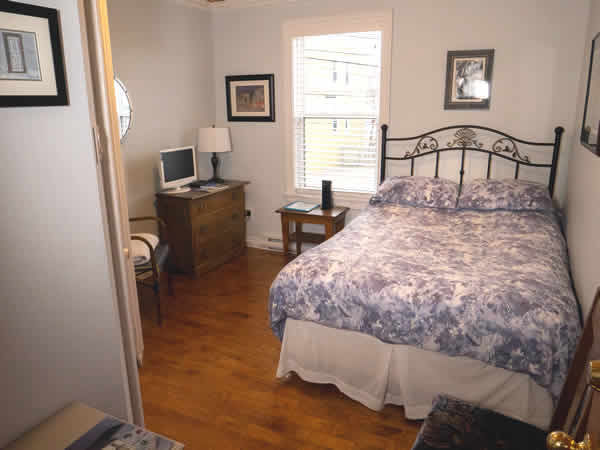 image: interior room with double bed, dresser and window